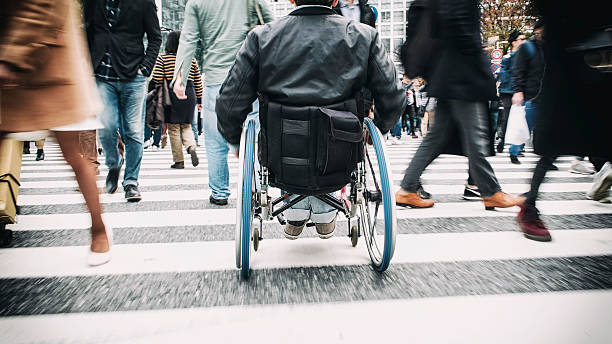 A person in a wheelchair crossing the street