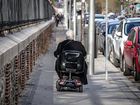 Scooter user on a sidewalk