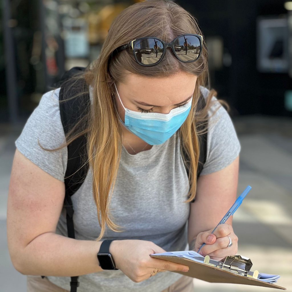 Aislynn Sharrock writing on a clipboard