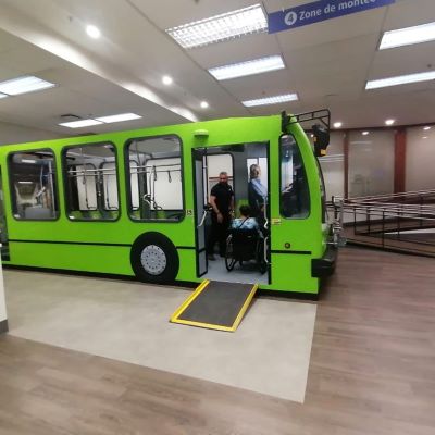 A green bus with an accessible ramp