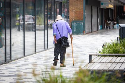 A person using a cane as a walking aid.