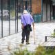 A person using a cane as a walking aid.