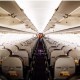 Inside an airplane looking between the aisles at the rows of seats.